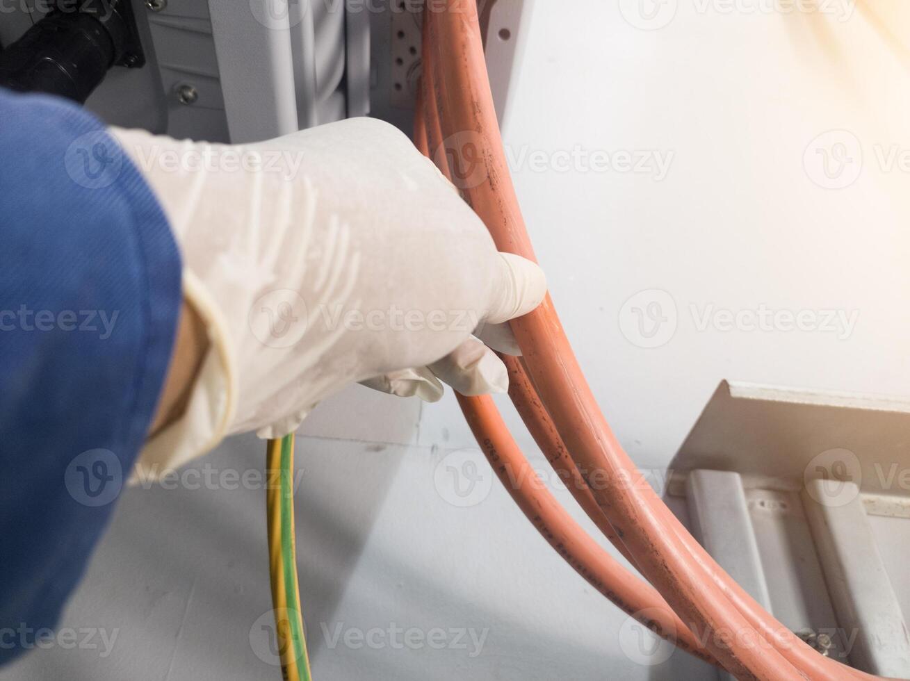 A engineering checking power cable lines in inverter solar panel. Electrical service concept. photo