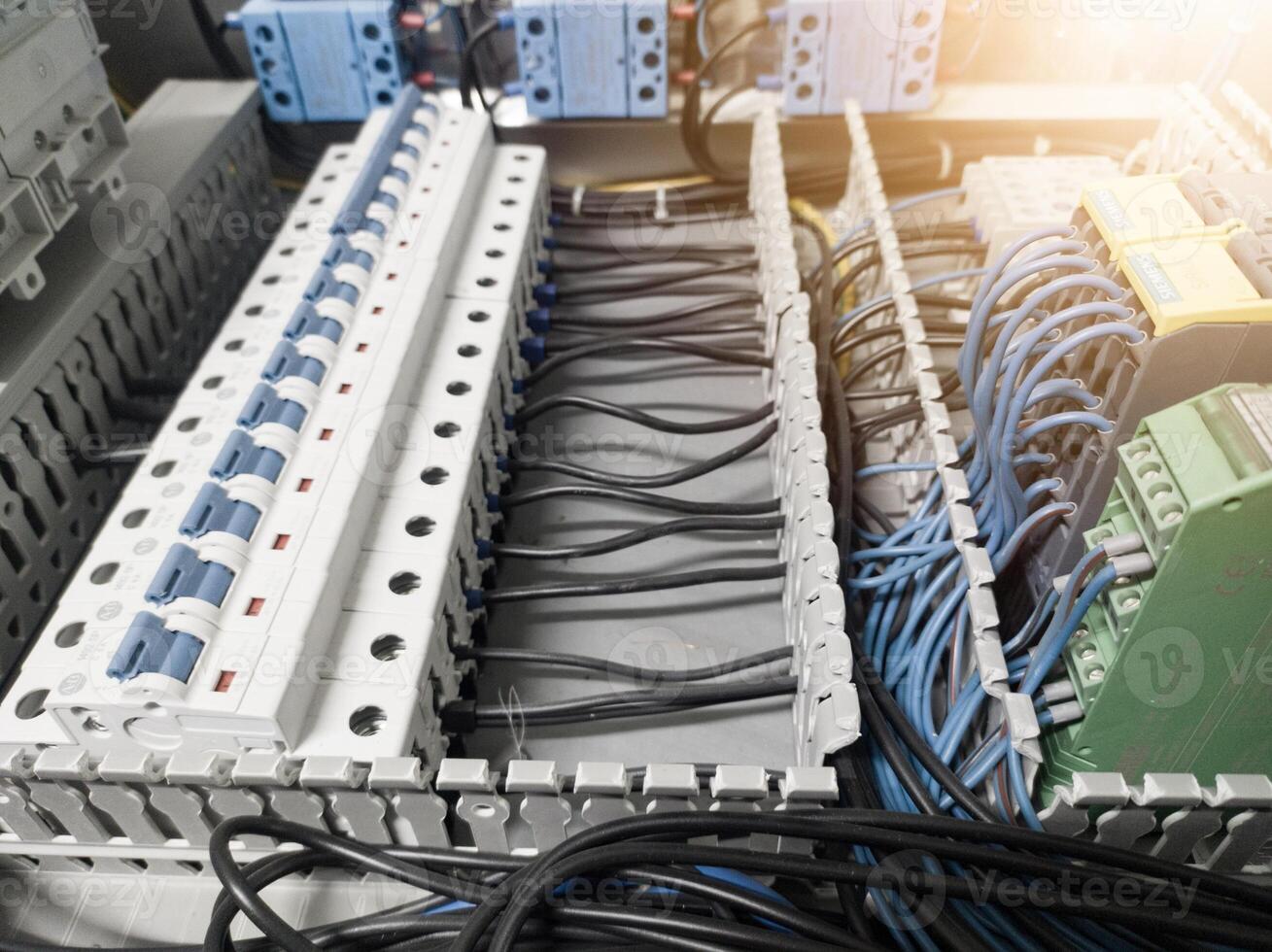 Voltage switchboard with circuit breakers on the panel board. Wire connection board. Electrical background photo