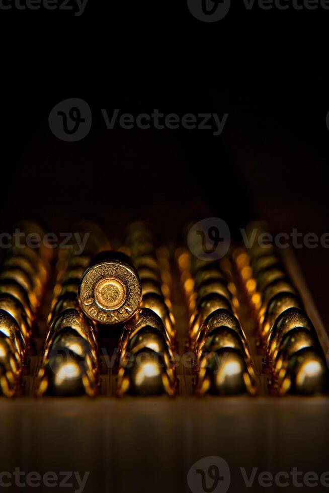 Pistol cartridges 9 mm. Ammunition for pistols and PCC carbines on a dark back photo