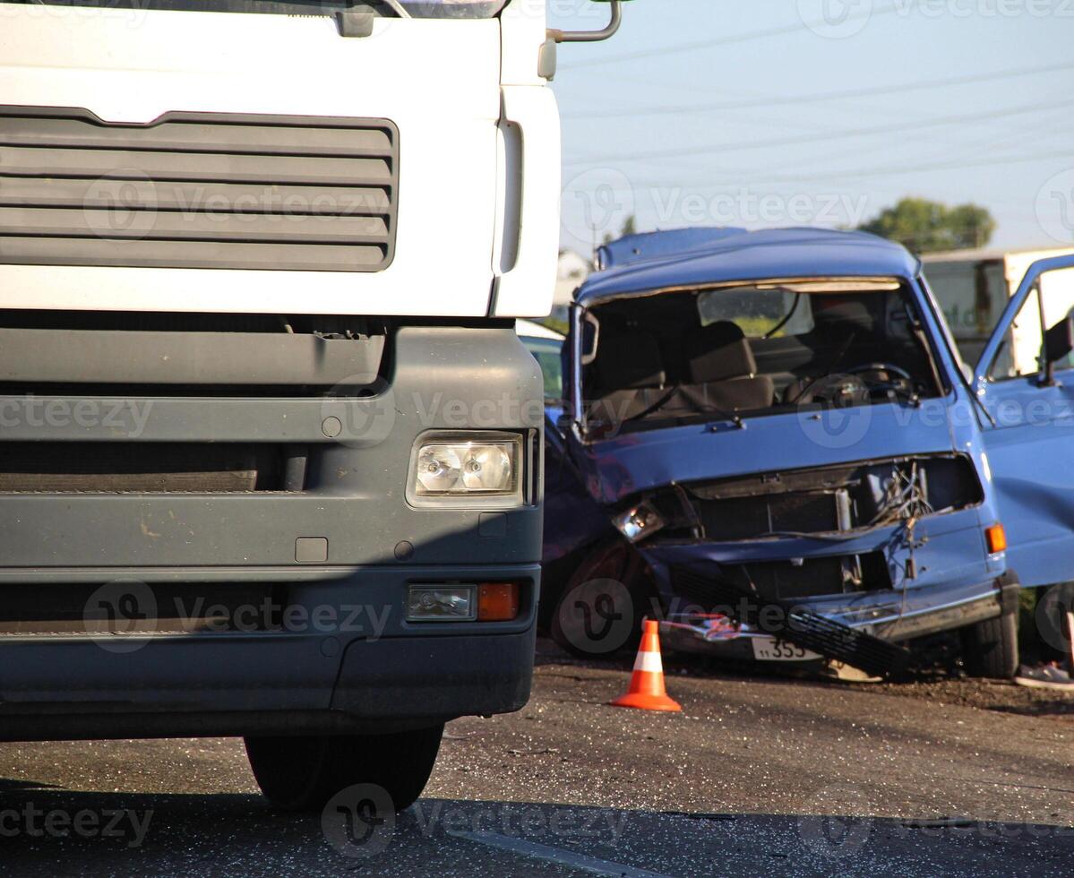 Vehicle Damaged After Collision With A Truck On A Highway photo