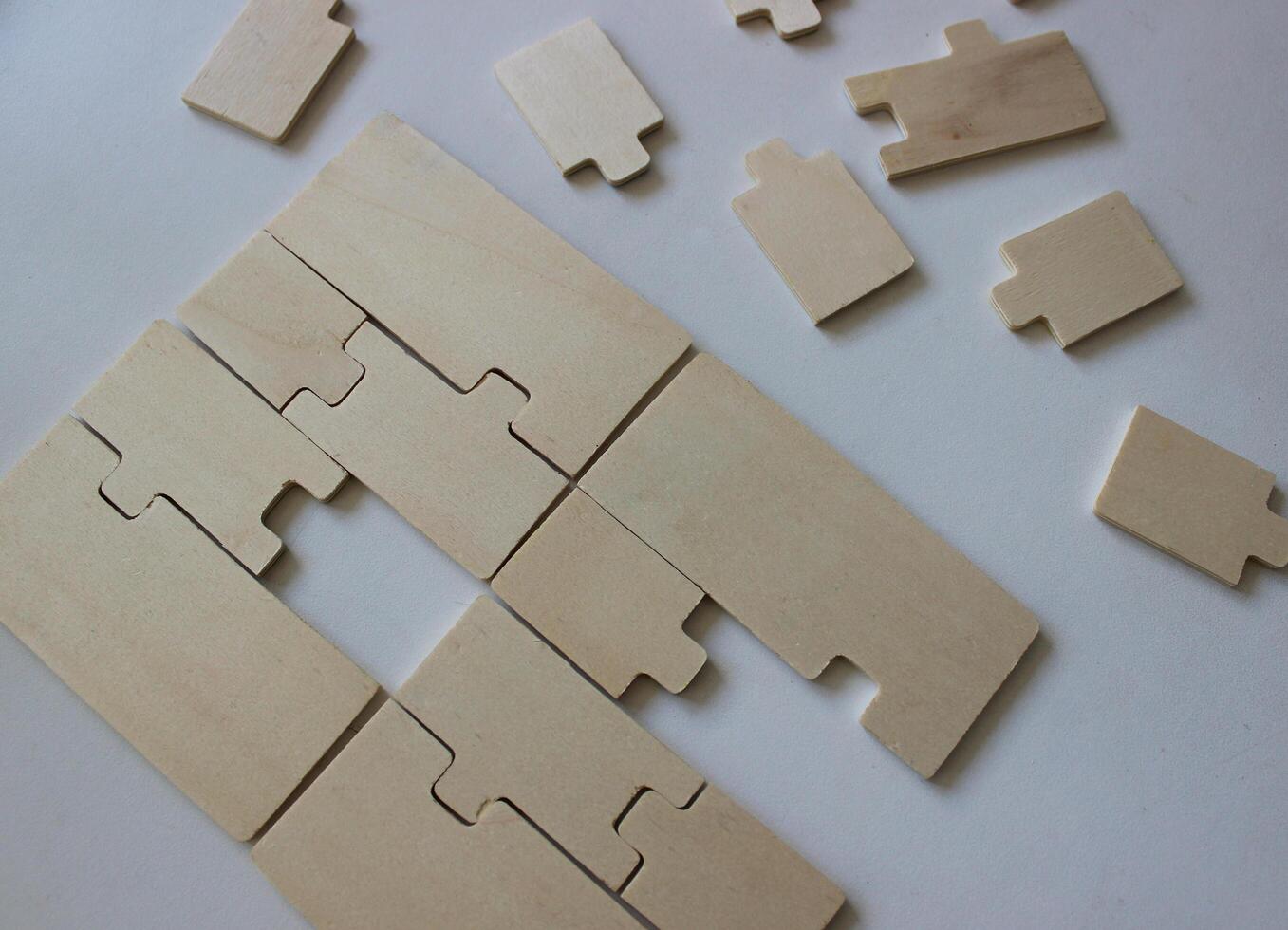 Assembling wooden puzzles with a missing piece and additional puzzles photo