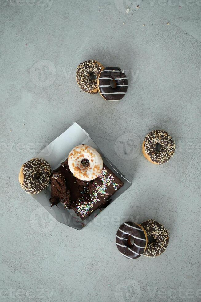 Donuts with chocolate frosted and sprinkles on a gray background photo