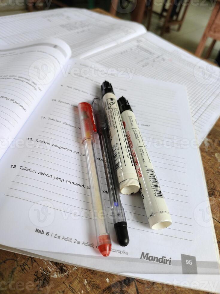 a pack of writing tools on a book photo