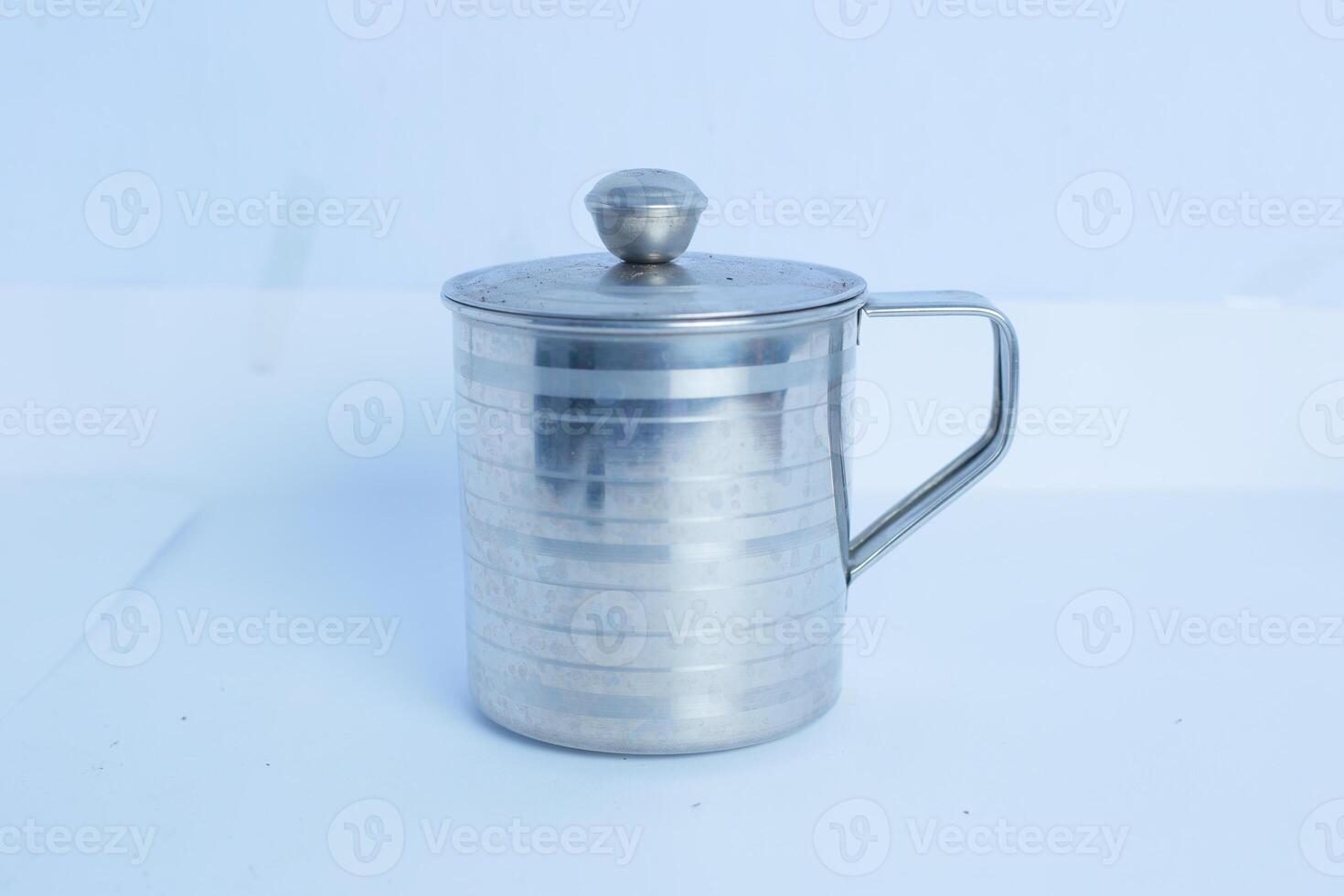 an iron glass that is on a white background table photo