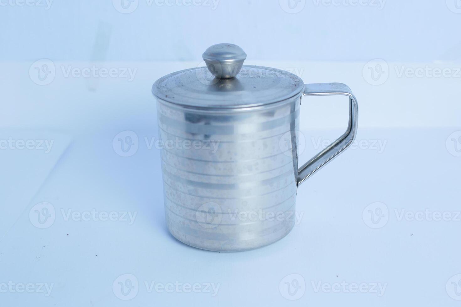 an iron glass that is on a white background table photo