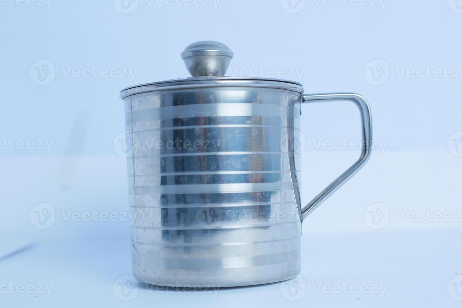 an iron glass that is on a white background table photo