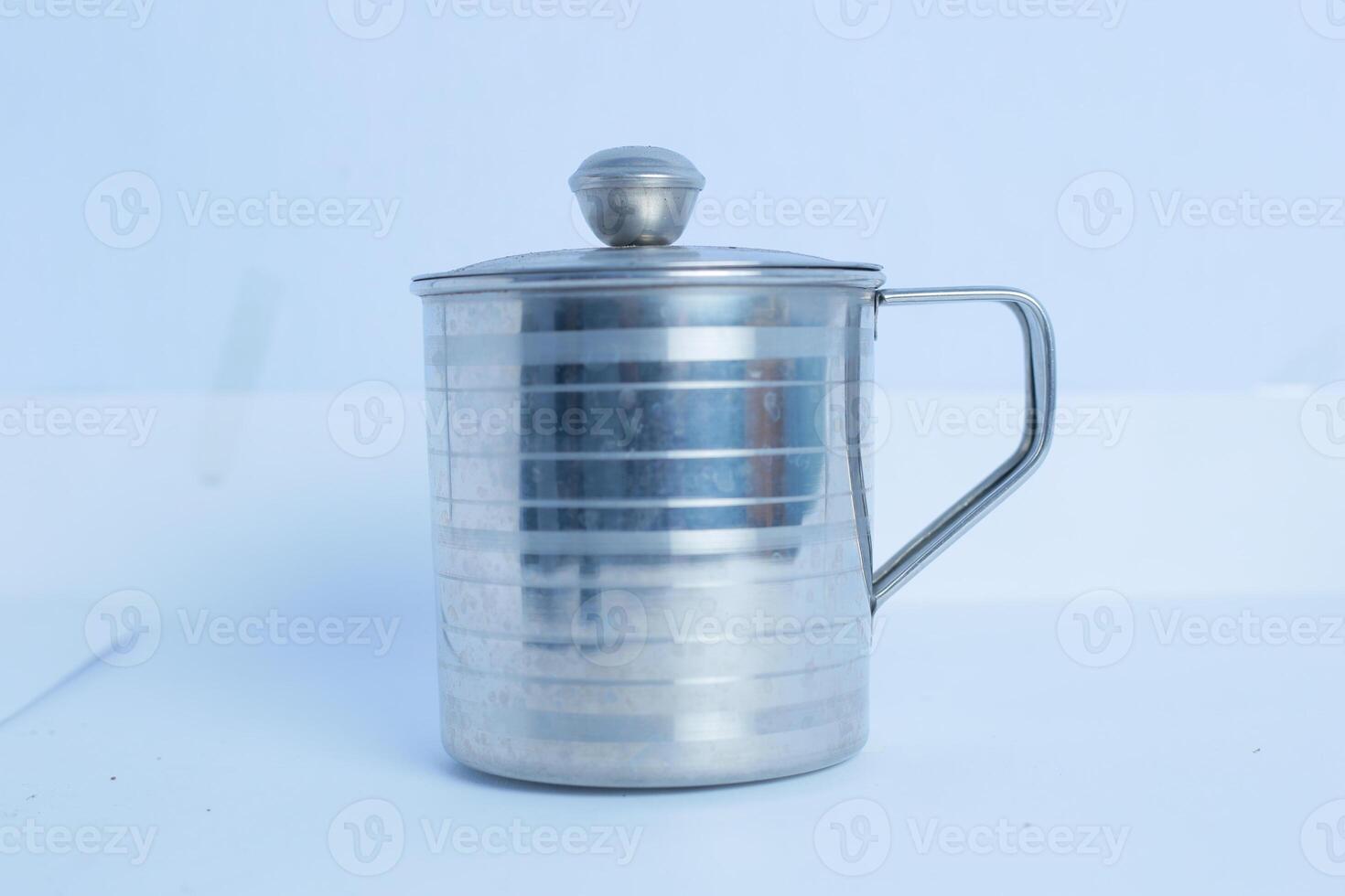 an iron glass that is on a white background table photo