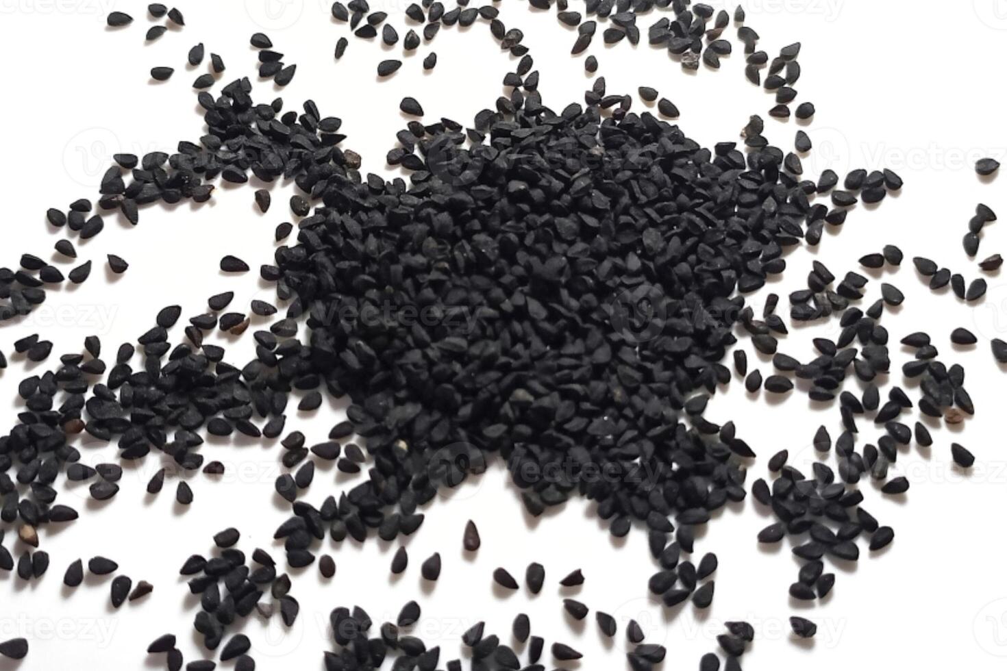 Black cumin seeds pile isolated on white background photo
