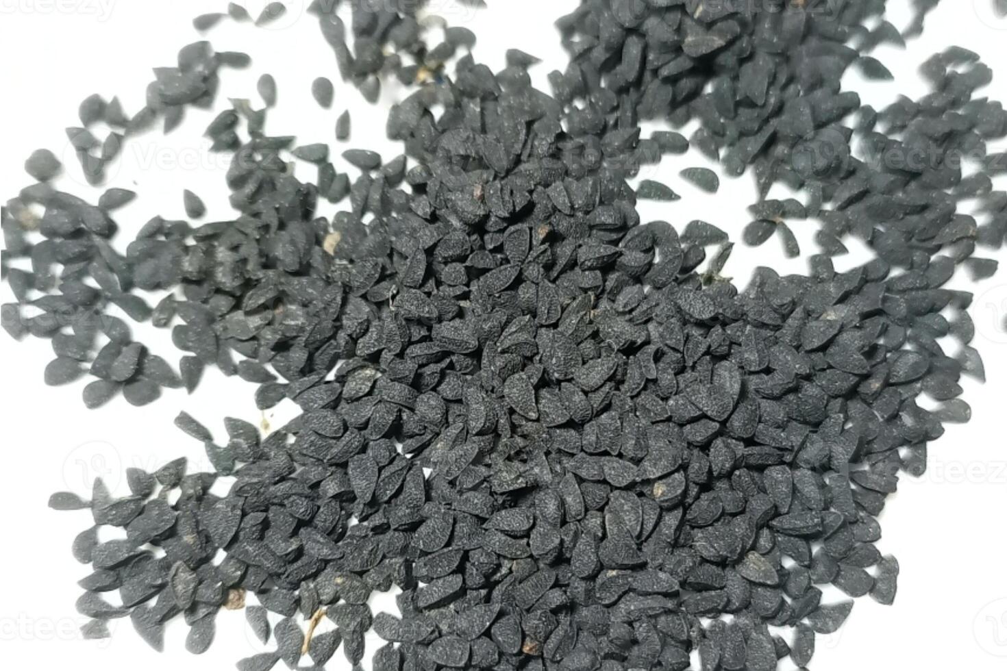 Black cumin seeds pile isolated on white background photo