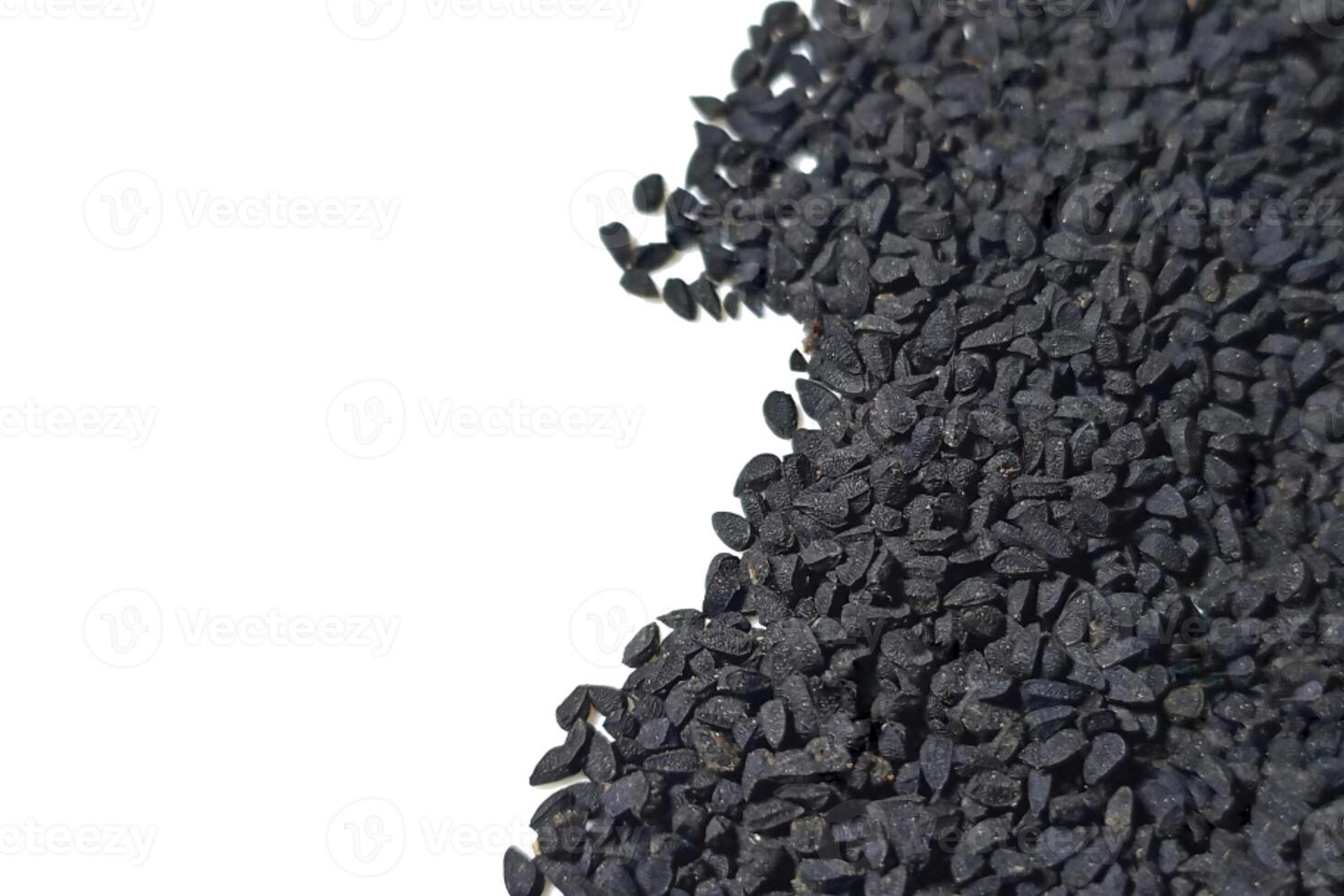 Black cumin seeds pile isolated on white background photo