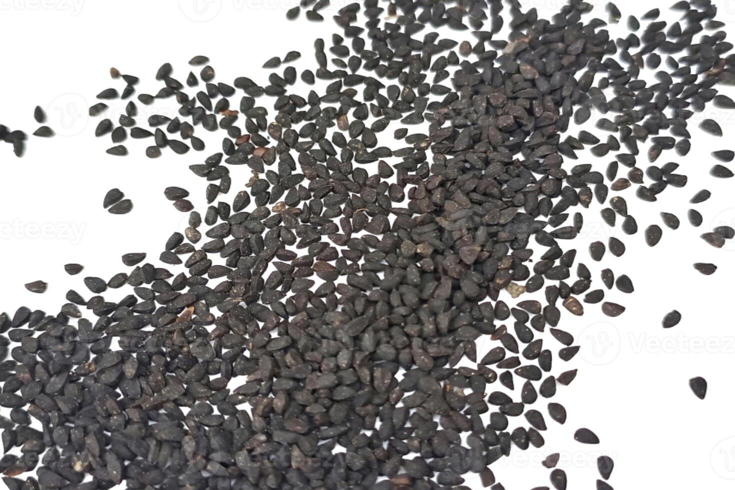 Black cumin seeds pile isolated on white background photo