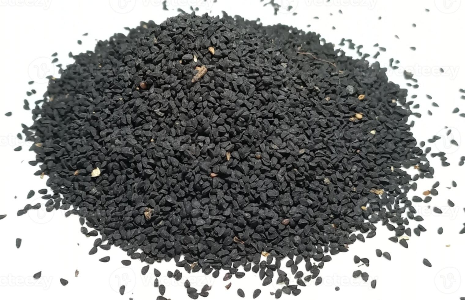 Black cumin seeds pile isolated on white background photo