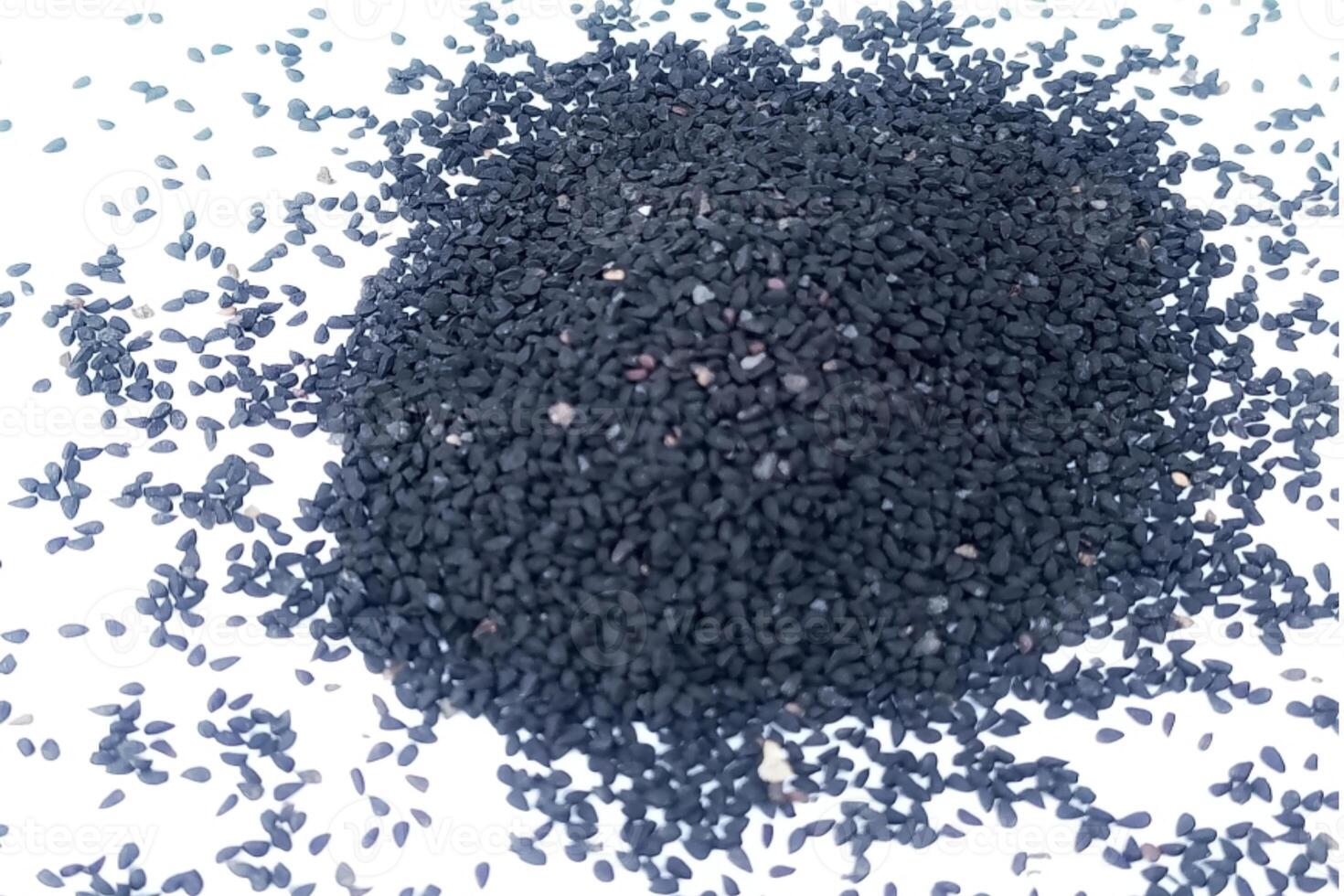Black cumin seeds pile isolated on white background photo