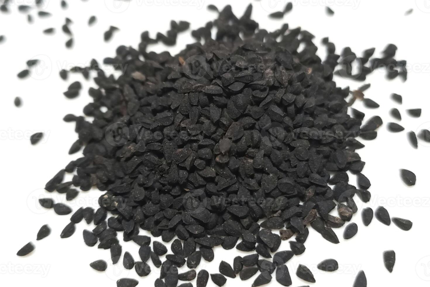 Black cumin seeds pile isolated on white background photo
