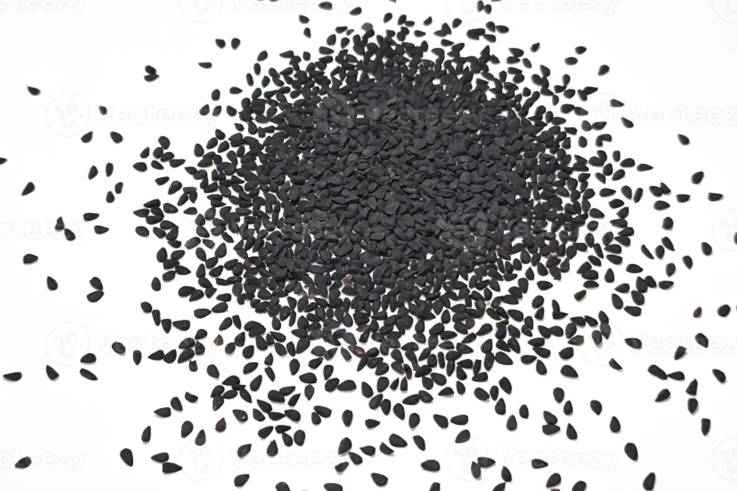 Black cumin seeds pile isolated on white background photo