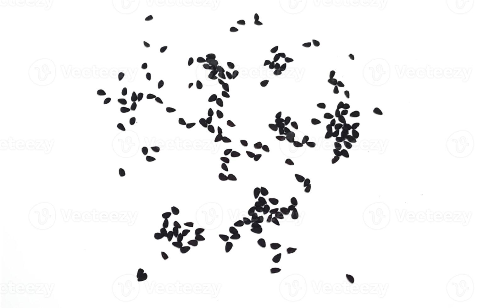 Black cumin seeds pile isolated on white background photo