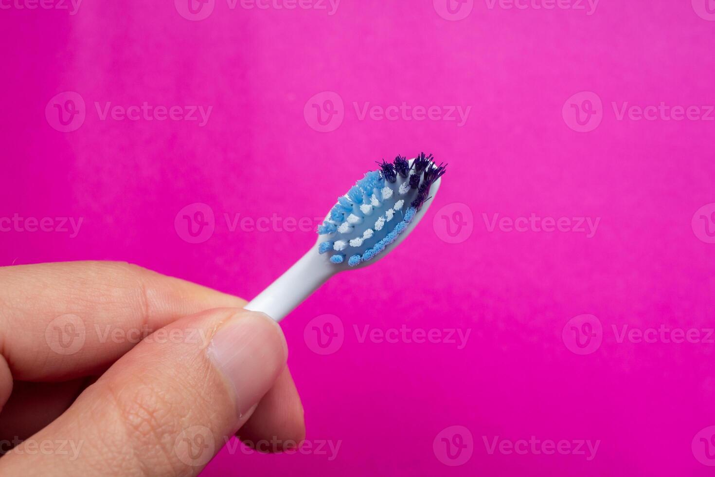 Used toothbrush isolated on pink background. Old toothbrush. Top view, copy space. photo