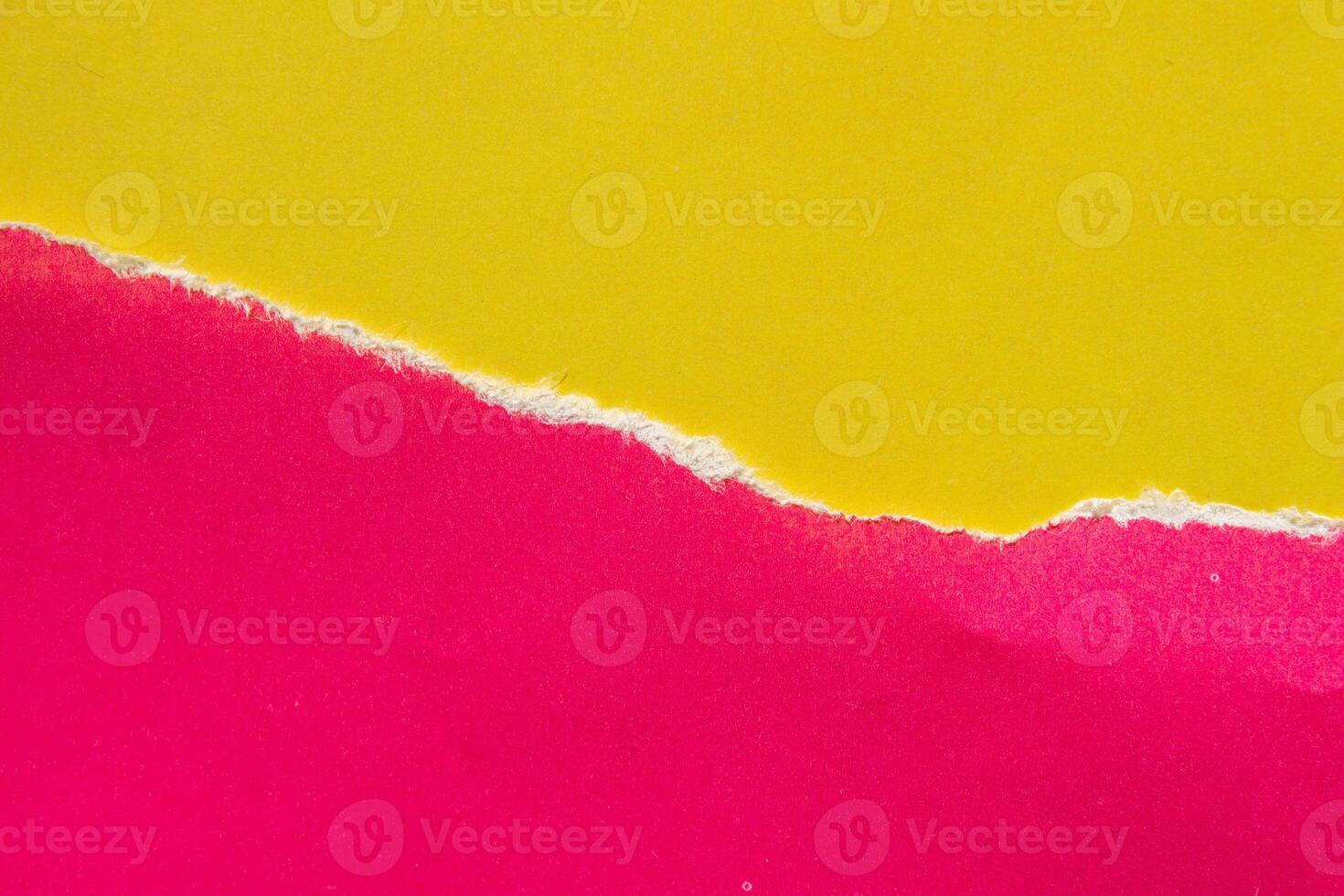 Ripped pink paper on yellow background. Torn paper background with copy space for text. photo