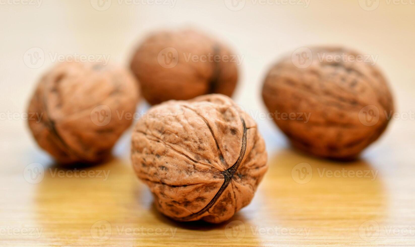 Three walnuts on a wooden table. Shallow depth of field. photo