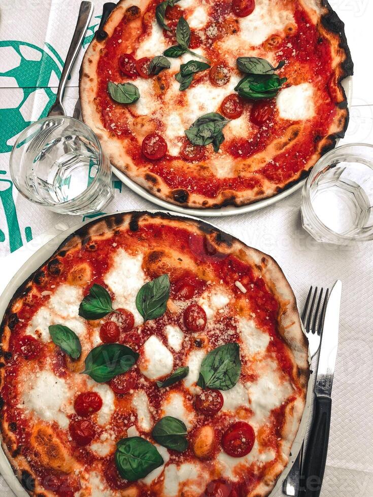 Pizza with mozzarella cheese, cherry tomatoes and basil. photo