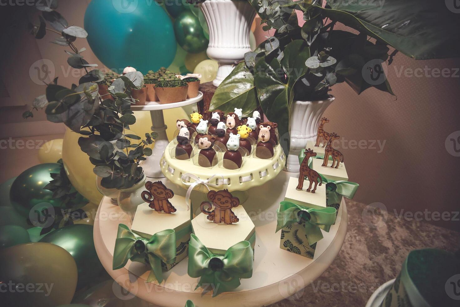 Birthday cake with cupcakes decorated with flowers and green ribbons photo