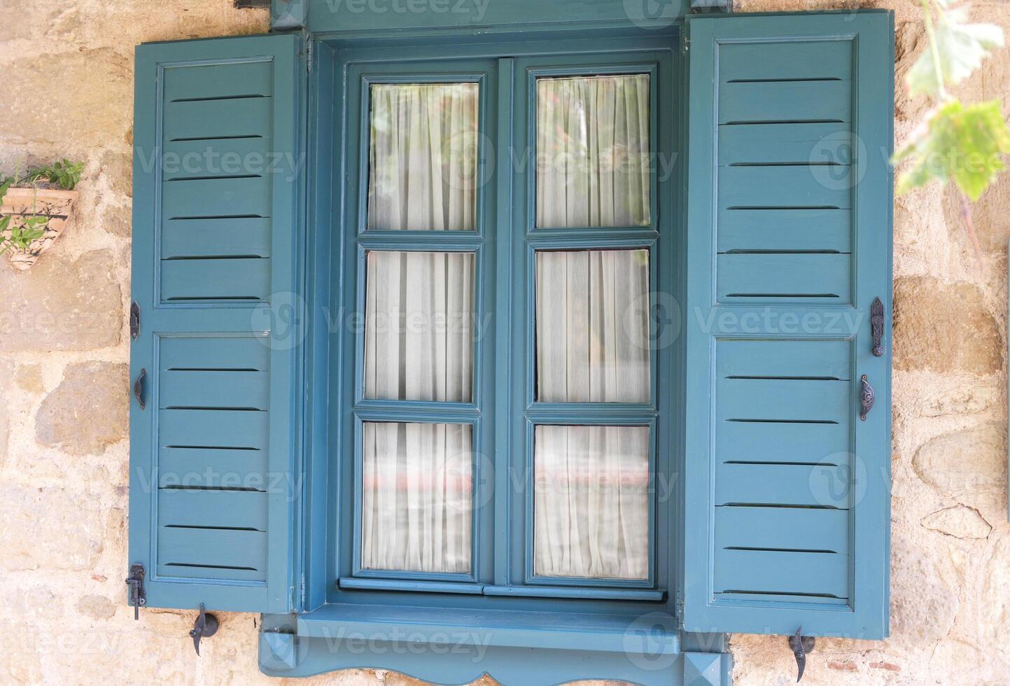 Vintage Teal Window Shutters on Stone Village House photo