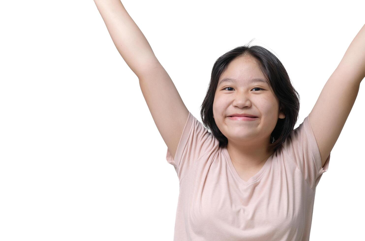 Cute girl wearing a t-shirt raises her hands and smiles happily. emotion photo