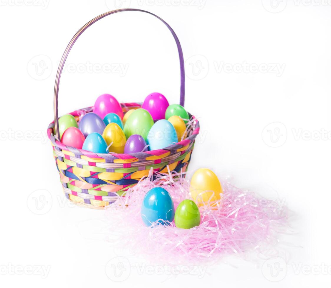 Colorful Easter Eggs In Multi Color Easter Basket And On A Bed Of Pink Grass photo
