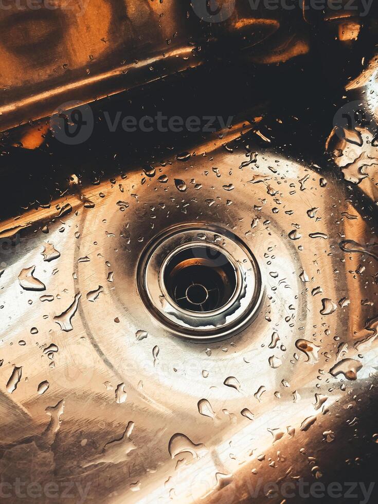 Wet stainless steel sink. Drops of water on stainless steel kitchen metal, modern home concept and resistant metal photo