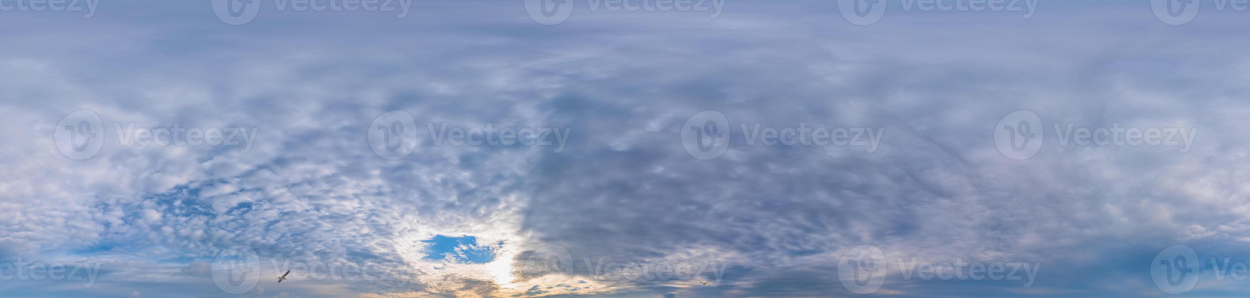Sunset sky panorama with Stratocumulus clouds in Seamless spherical equirectangular format. Full zenith for use in 3D graphics, game and editing aerial drone 360 degree panoramas for sky replacement. photo