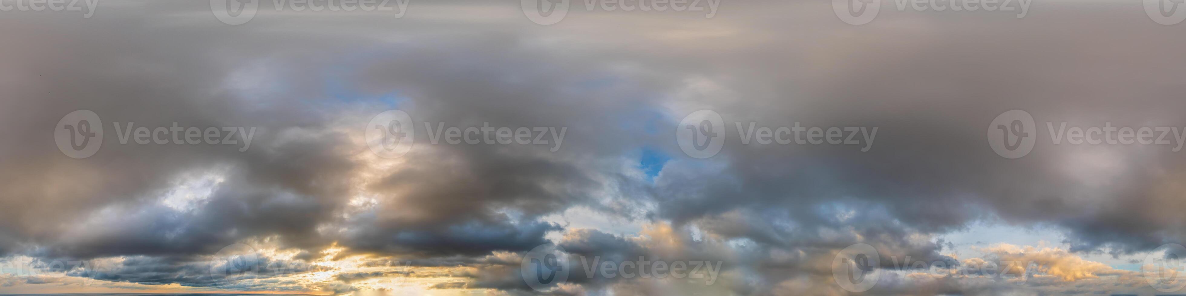 Seamless sky panorama on sunset with multi layered clouds in spherical equirectangular format with complete zenith for use in 3D graphics, game and for aerial drone 360 degree panoramas as a sky dome. photo