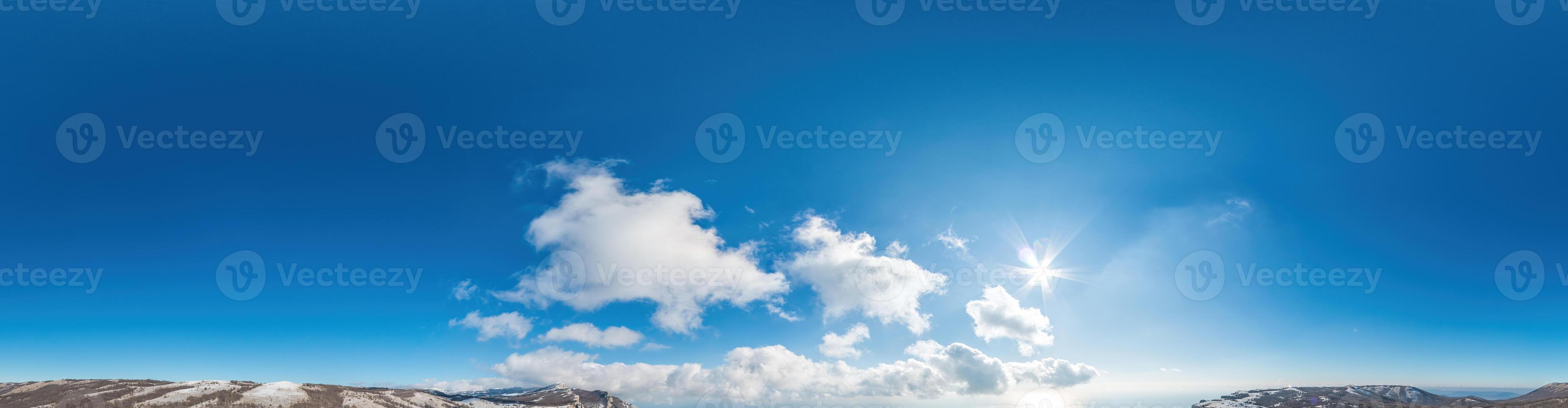 Seamless panorama of sky with light clouds in spherical equirectangular format with complete zenith for use in 3D graphics, game and for composites in aerial drone 360 degree panoramas as a sky dome. photo