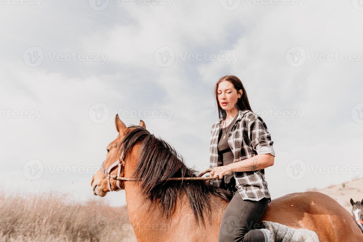 Young happy woman in hat with her horse in evening sunset light. Outdoor photography with fashion model girl. Lifestyle mood. Concept of outdoor riding, sports and recreation. photo