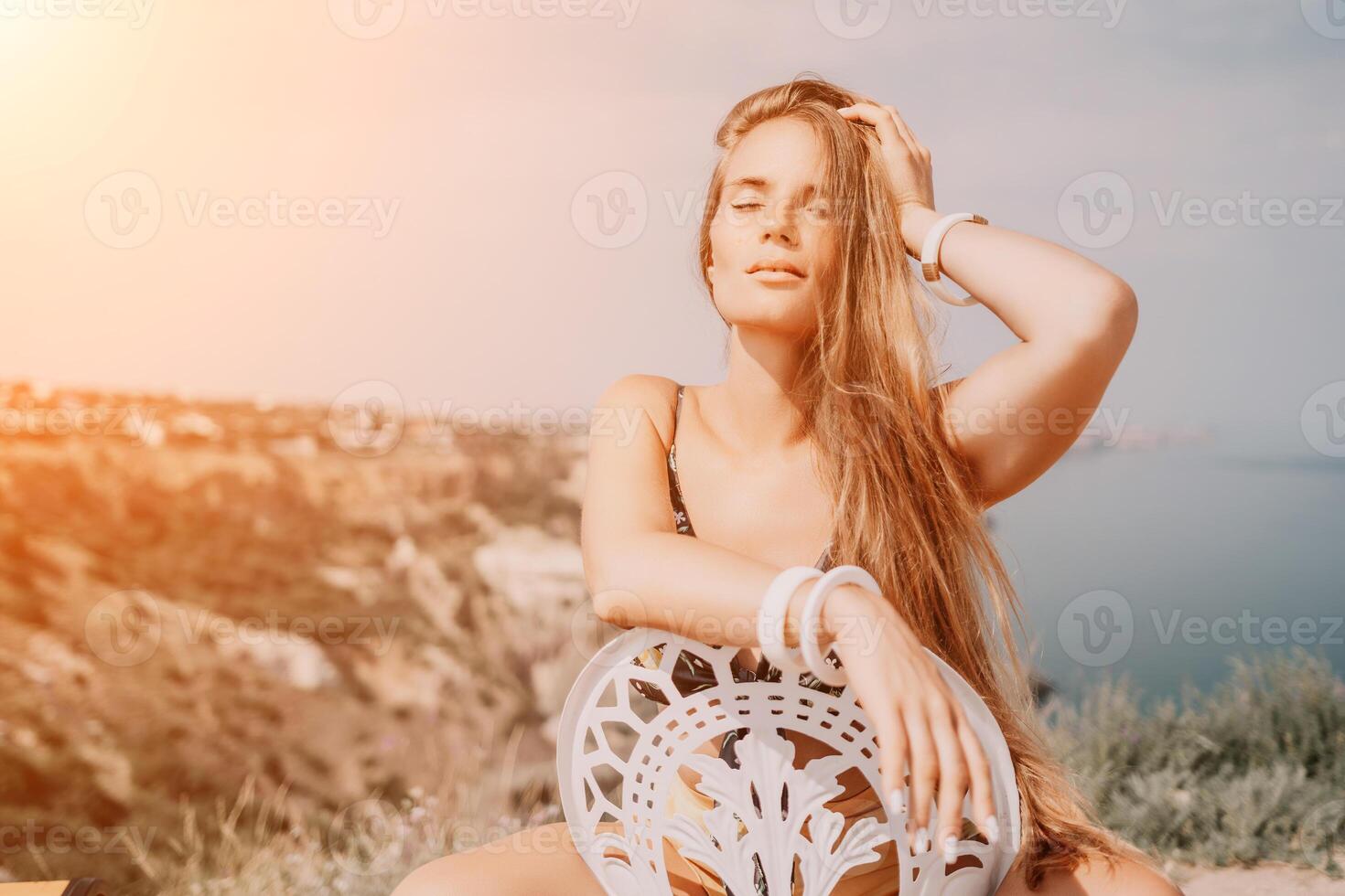 Happy boho woman portrait. Boho chic fashion style. Outdoor photo of free happy woman with long hair, sunny weather outdoors with sea mountains nature beautiful background.