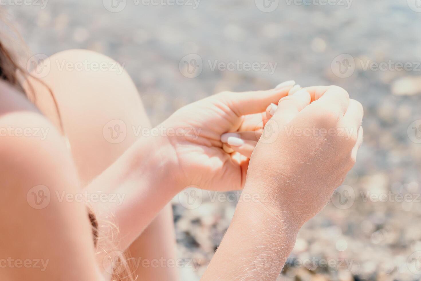 Woman eating milky almond nuts. A young caucasian woman chopping fresh green almond after morning fitness yoga near sea. Only hands are visibly. Healthy vegan food. Slow motion. Close up photo