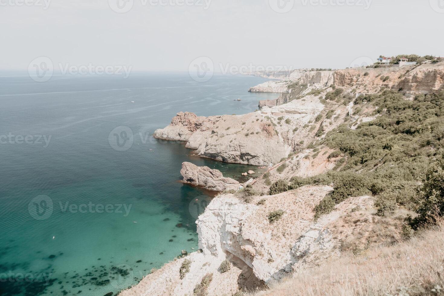 Aerial view from above on calm azure sea and volcanic rocky shores. Small waves on water surface in motion blur. Nature summer ocean sea beach background. Nobody. Holiday, vacation and travel concept photo
