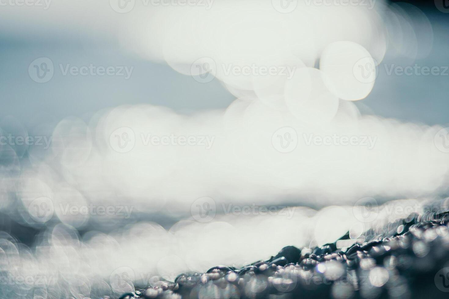 Abstract nature summer ocean sunset sea background. Small waves on water surface in motion blur with bokeh lights from sunrise. Holiday, vacation and recreational background concept. photo