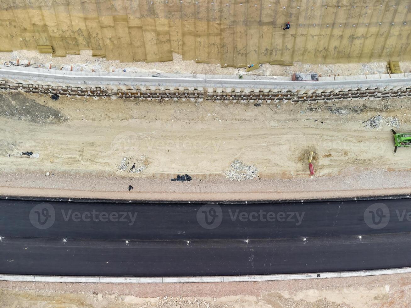 Mountain road constraction. Workers reinforce the slope over the new road. Road construction in progress on slope nature canyon. Infrastructure development and logistics. Aerial drone shot photo