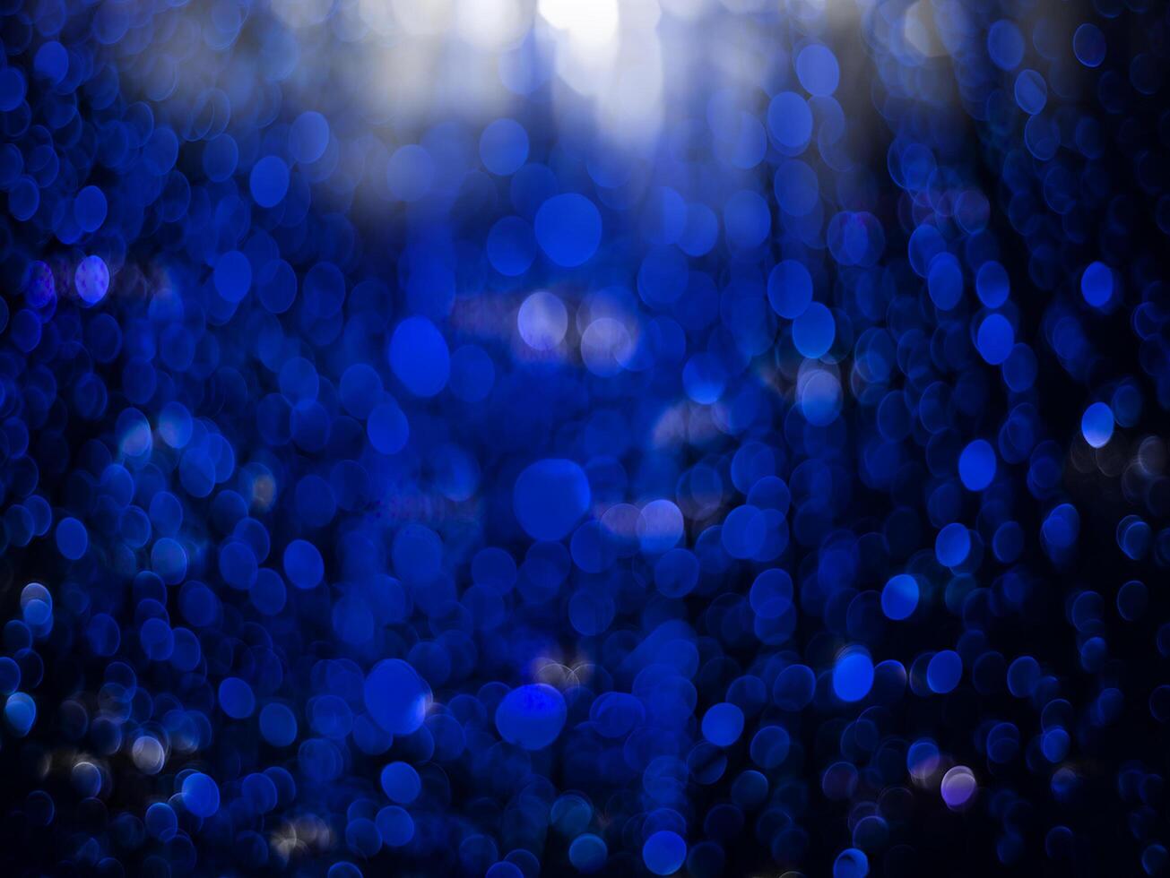 Blue sparkling glitter bokeh background. photo