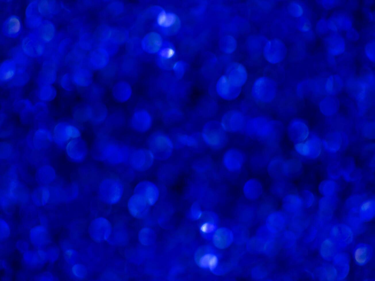 Blue sparkling glitter bokeh background. photo