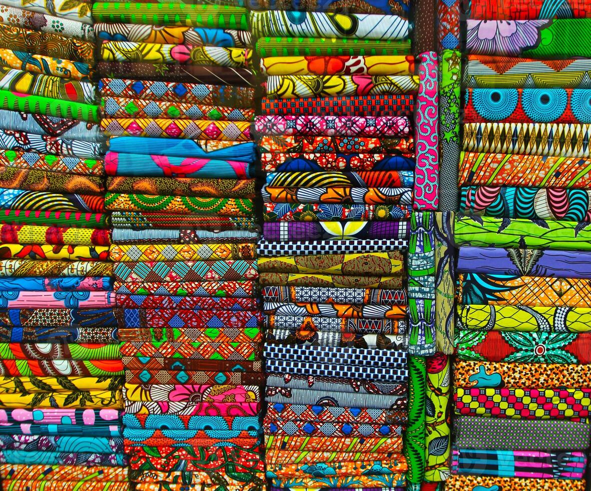 Stacks of bright colorful fabrics. Shopping, consumerism concept photo