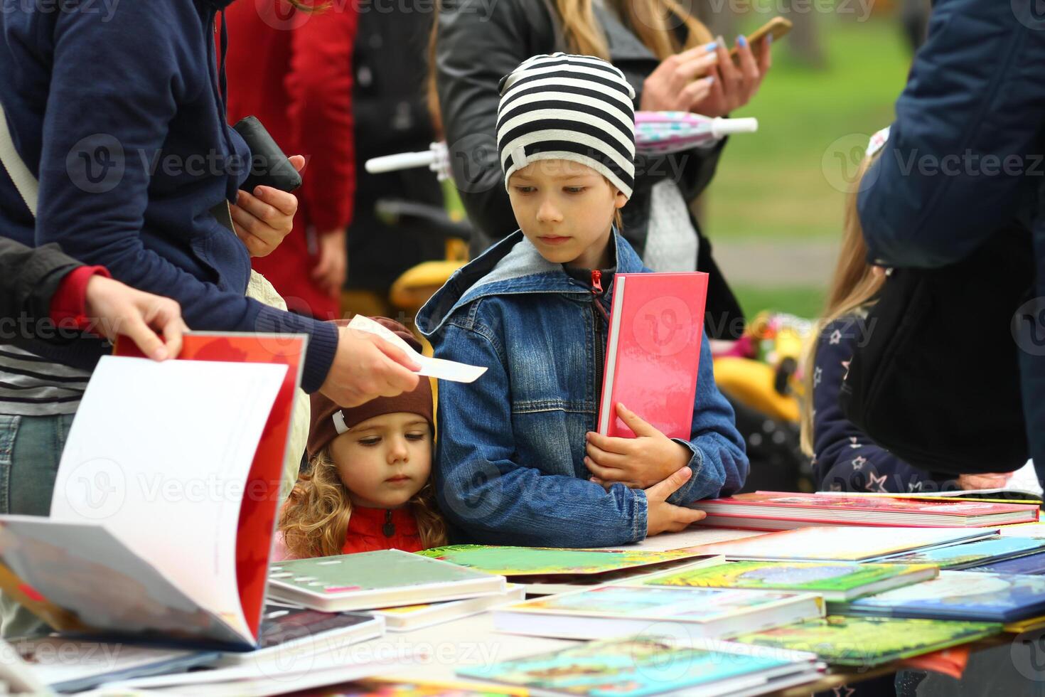 Children choosing and buying books at the book fair photo