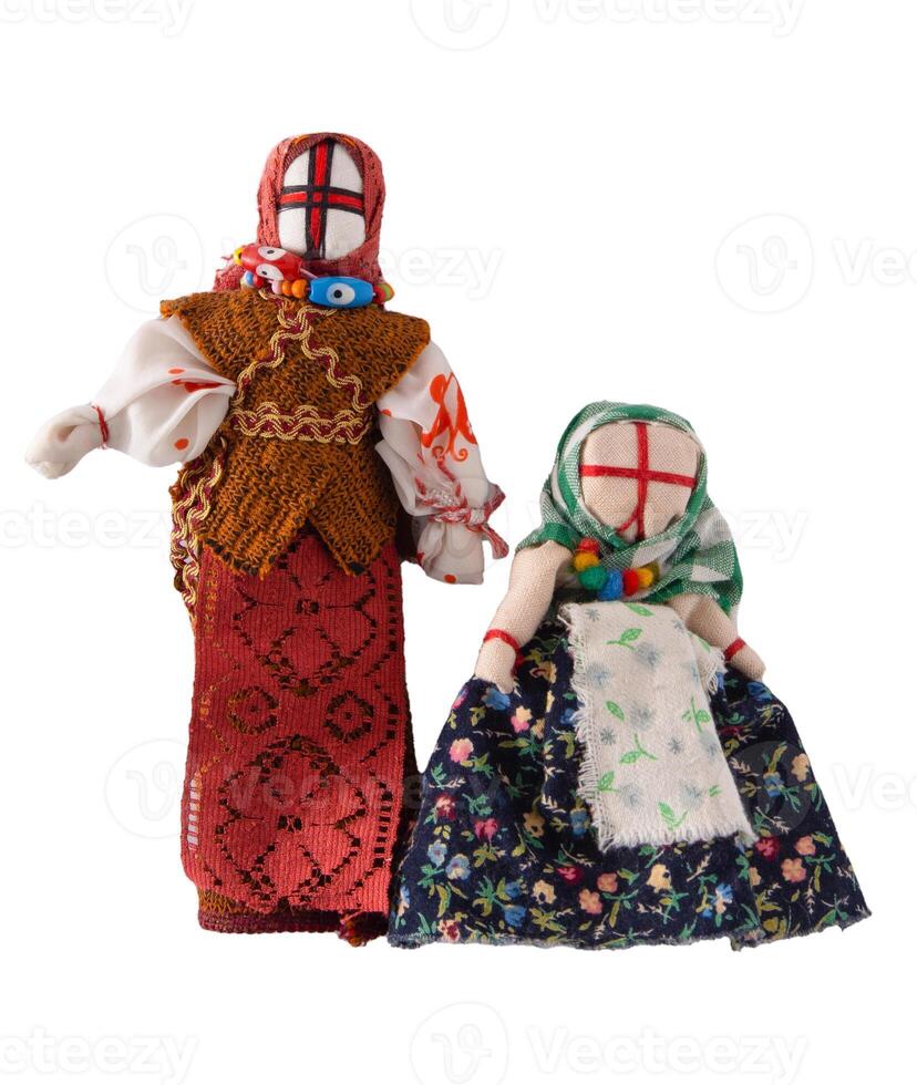 Lyalka motanka handmade. Ukrainian national doll amulet, silt patches and threads are made without a needle. Symbol of Ukraine. Motanka dolls on a white background. photo