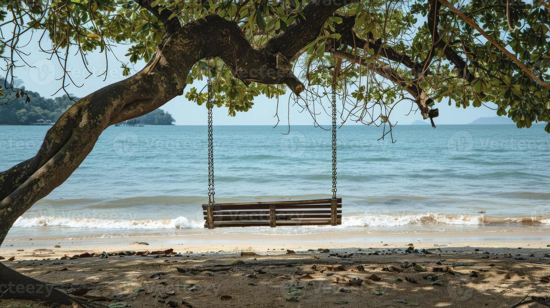 AI generated A wooden bench swing hanging from the branch of an old tree on a beach photo