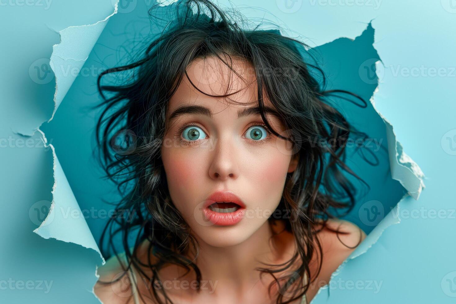 AI generated A woman's face expresses shock and curiosity as she peers through a torn teal paper, capturing a moment of surprise and intense emotion photo