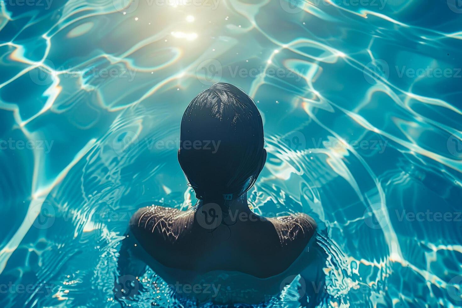 AI generated A person in contemplation, immersed in the sparkling blue waters of a swimming pool, with sunlight dancing on the surface photo