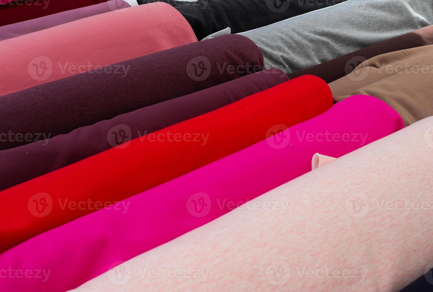 Detailed close up view on samples of cloth and fabrics in different colors found at a fabrics market photo