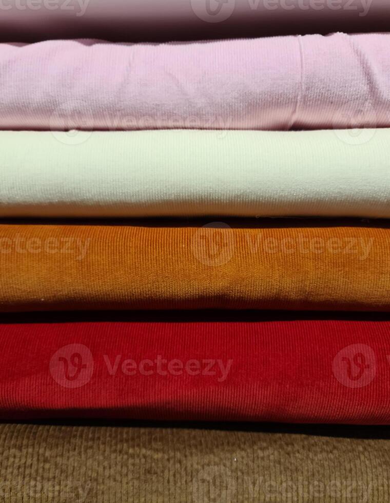 Detailed close up view on samples of cloth and fabrics in different colors found at a fabrics market photo