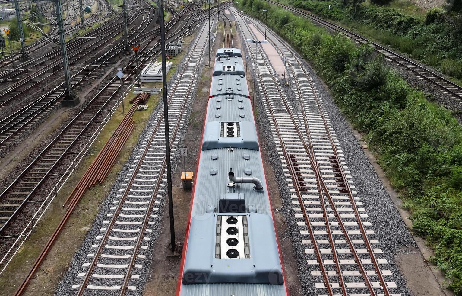 Multiple railroad tracks with junctions at a railway station in a perspective and birds view photo
