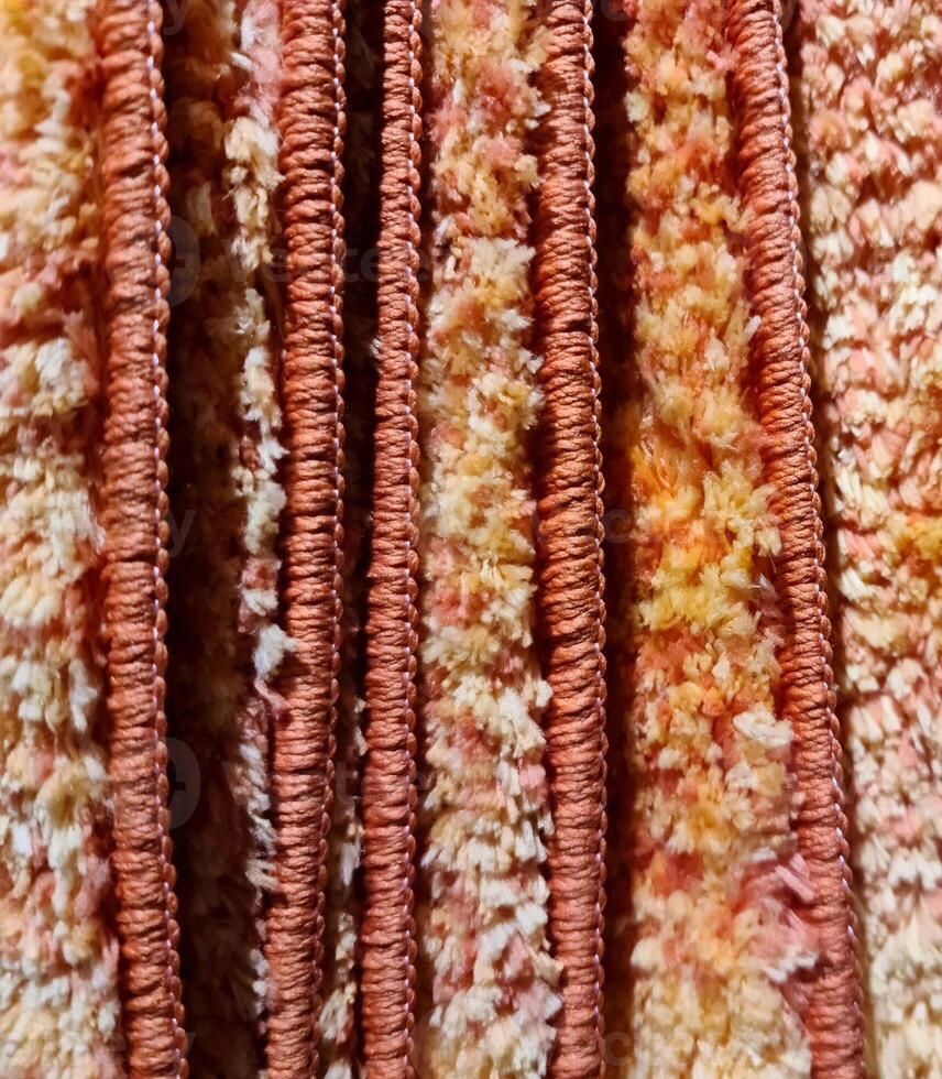 Detailed close up view on samples of cloth and fabrics in different colors found at a fabrics market photo